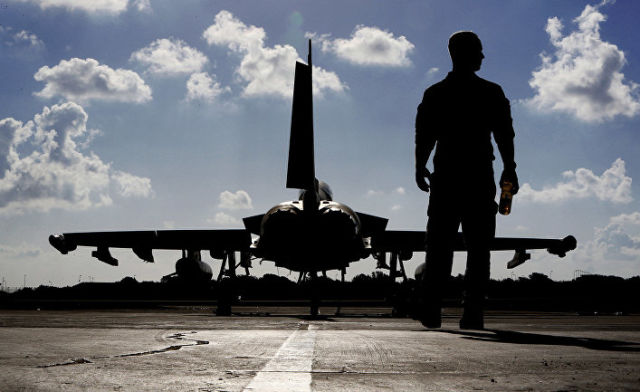 Британский военный возле истребителя "Тайфун" перед взлетом в Ирак