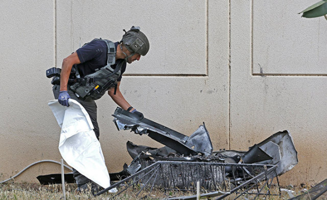 Израильский сапер проверяет остатки ракеты, запущенной с территории сектора Газы, в городе Ашкелон