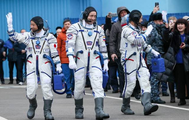 Космонавт Роскосмоса Александр Мисуркин (в центре), японский космический турист Юсаку Маэдзава (слева) и Едзо Хирано (справа)
