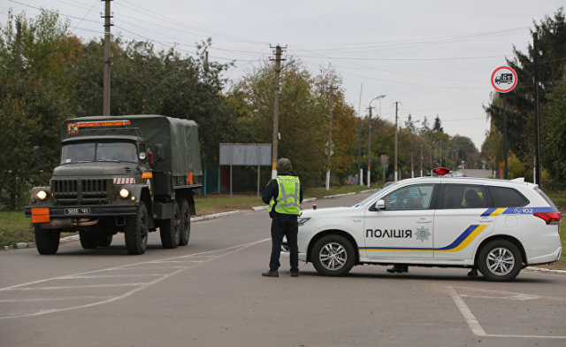 Сотрудники полиции Украины останавливают автомобили на дороге в Черниговской области после взрыва на военном складе. 9 октября 2018
