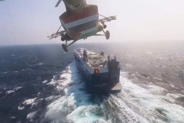 Военный вертолет хуситов пролетает над грузовым кораблем Galaxy Leader в Красном море